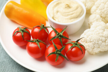 Different fresh vegetables and sauce on table, closeup