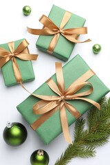 Beautiful Christmas composition with gifts and decor on white background, flat lay