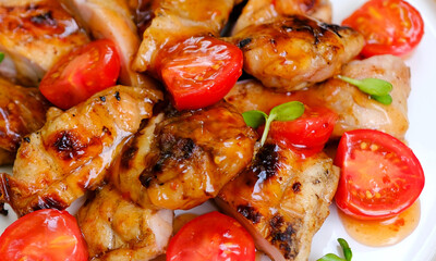Barbecue Glazed Chicken Wings with Tomato Garnish. High quality photo