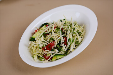 A bowl of freshly shredded white and green cabbage, perfect for healthy salads or coleslaw recipes, ideal for summer picnics. High quality photo