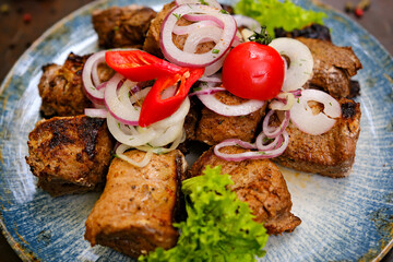 Assorted delicious grilled meat with vegetable. Mixed grilled bbq meat with vegetables. Set of shish kebabs or barbecue shashlik collection. Baked potatoes and fresh tomatoes. . High quality photo