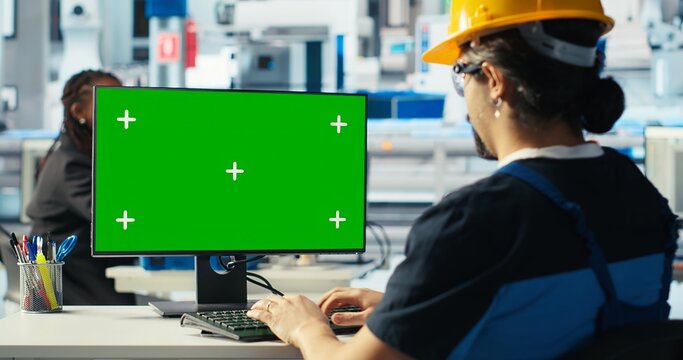 Photovoltaics factory engineer using green screen PC to adjust system parameters. Technician optimizing energy supply in solar panel manufacturing plant using chroma key computer, camera B