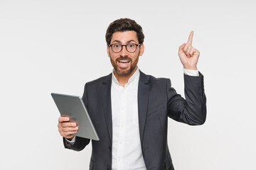 Have idea! Happy business man entrepreneur, excited professional investor trader wearing suit holding digital tablet celebrating success trade deal standing isolated on white background.