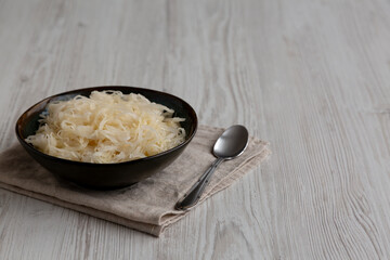 Organic White German Sauerkraut in a Bowl, side view. Copy space.