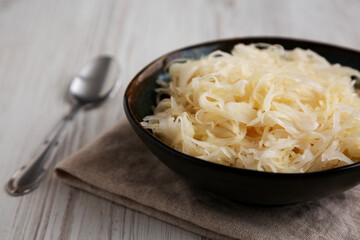 Organic White German Sauerkraut in a Bowl, side view. Close-up.