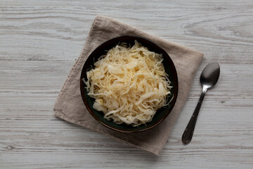Organic White German Sauerkraut in a Bowl, top view. Overhead, flat lay.