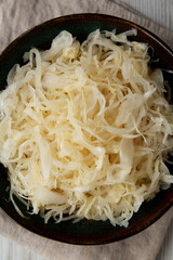 Organic White German Sauerkraut in a Bowl, top view. Close-up.