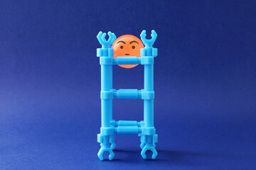 Sad sphere trapped in a structure made of plastic pieces