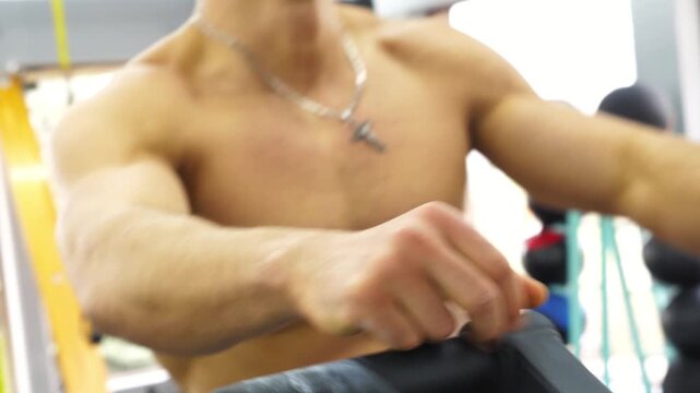 Athletic man engaged in intense workout session, showcasing determination and effort while exercising in a modern gym environment, emphasizing physical fitness and commitment to health