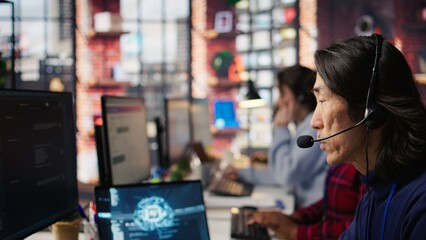 Call center agents track shipments in office using AI chatbot for help. Customer center workers use...