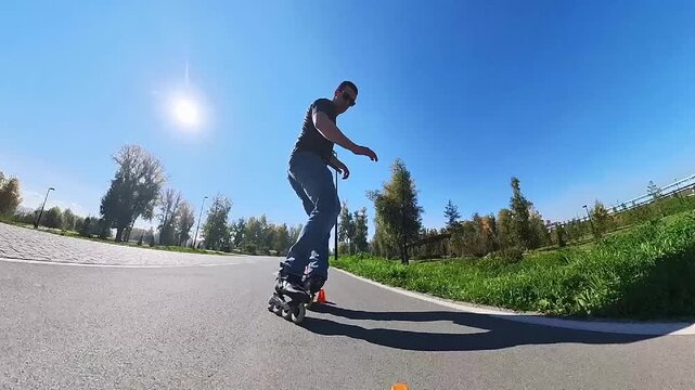 A Caucasian man rollerblades around the slalom course.