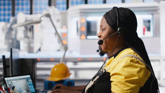 Solar energy female expert providing remote support in solar panel plant, working in customer support call center. Technician sales representative offers maintenance, high tech factory. Camera A.