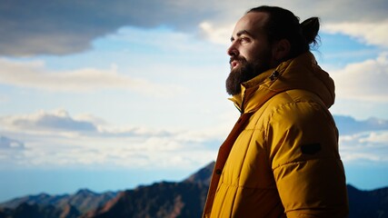 Traveler stands alone in the high altitude wilderness admiring the breathtaking scenery, enjoying...