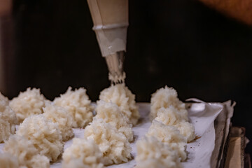 Alsatian coconut macaroons cookies baking at Strasbourg Christmas market, France