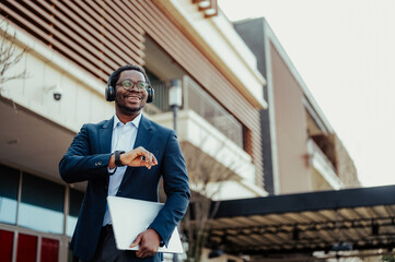 Happy businessman checking time listening music