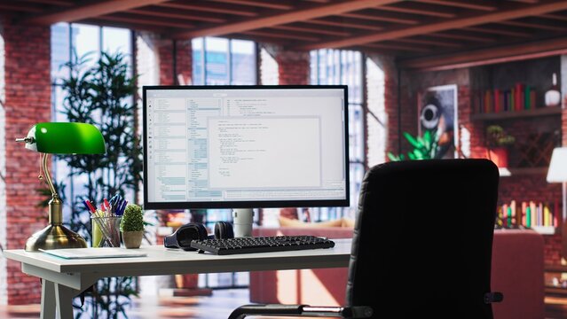 Modern loft with desktop monitor ready for coding and programming tasks, spacious workspace . Perfect environment for developing secure applications and online software systems.