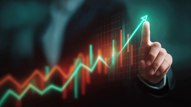 Businessman pointing at rising stock market graph