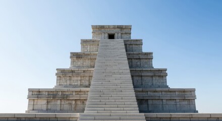 Ancient stone pyramid temple with grand staircase under clear blue sky