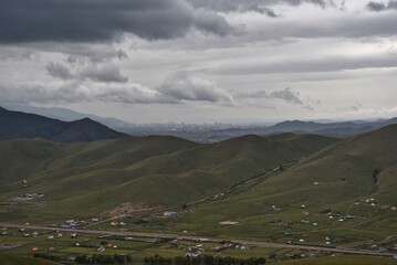 Gray skies over green hills