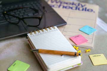 Notebook planner and organizer on a desk with laptop 