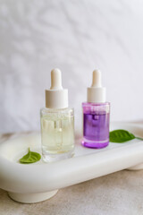 Bakuchiol face serum in a glass bottle on shadows background 