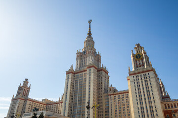 View of the main building of Moscow State University. High-rise building with a spire. Skyscraper in neoclassical style. Architectural dominant and landmark of Moscow. Higher education in Russia.