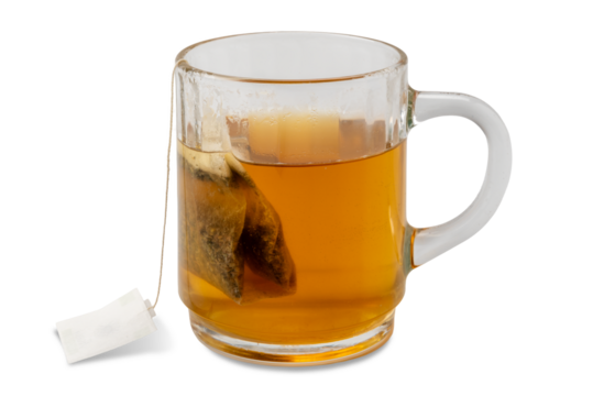 Relaxing digestive herbal tea with chamomile and licorice in a filter bag to be steeped in boiling water in a glass cup isolated