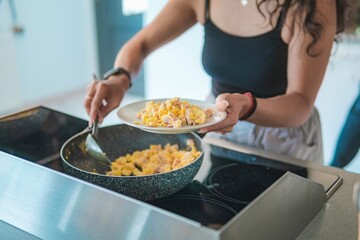Home cook preparing breakfast. Woman preparing eggs for the family's breakfast.