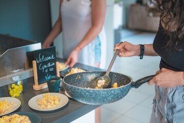 Home cook preparing breakfast. Woman preparing eggs for the family's breakfast.