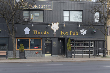 Fototapeta premium exterior building facade and sign of Thirsty Fox Pub, a pub, located at 1028 eglinton Av W, Toronto