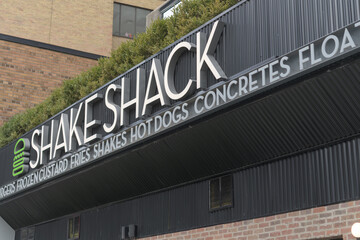 Fototapeta premium exterior building facade and sign of Shake Shack, a hamburger restaurant, located at 40 Eglinton Av E, Toronto