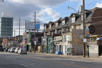 Fototapeta premium looking northwest on Dupont St just east of Spadina Rd (north side) to commercial ribbon and signs, Toronto