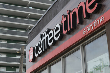 Fototapeta premium exterior building facade and sign of Coffee Time located here at 1471 Eglinton Av W, Toronto
