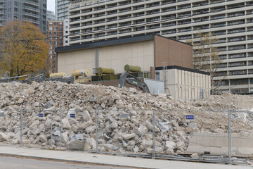 Fototapeta premium demolition of building (90 Eglinton Av W) near Yonge Eglinton featuring automobile, scaffolding, heavy construction machinery, and rubble, Toronto