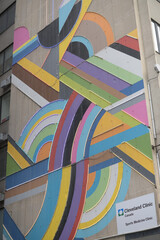 Fototapeta premium Madison Group’s illuminated mural by David Guinn, Drew Biliau, and Marnie Mandel and sign of Cleveland Clinic Canada Midtown, 150 Eglinton Av E, Toronto