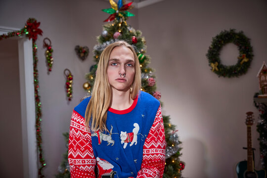 Alternative Christmas style with festive cat sweater and nose piercing in decorated holiday home