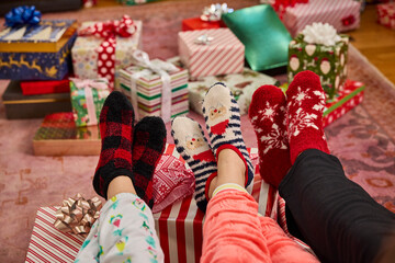 Cozy holiday vibes with festive socks and beautifully wrapped christmas gifts under the tree