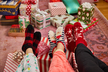 Cozy holiday vibes with festive socks and beautifully wrapped christmas presents under the tree