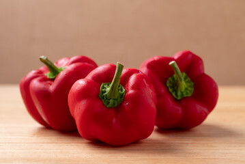 Fresh red bell pepper or sweet pepper on wooden background