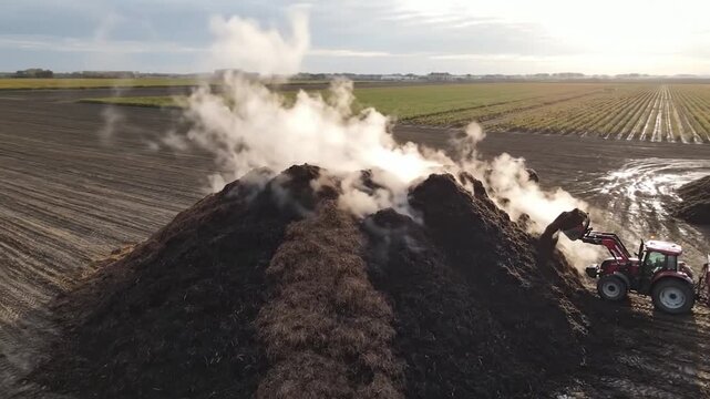 Composting process with tractor and steam in the field.