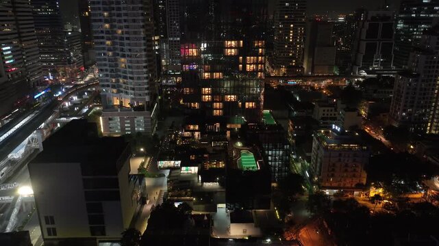 night time illumination bangkok city downtown famous modern skyscraper exterior aerial panorama 4k thailand 