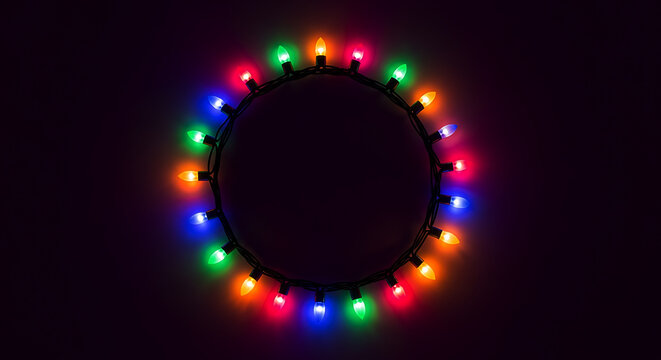 Circle of colorful glowing Christmas lights on dark background string festive