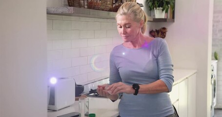 Woman opening pill bottle pouring tablets taking pill with water for health purple overlay kitchen