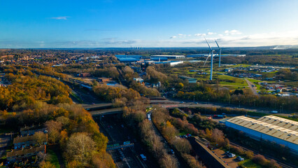 Industrial wind turbines near motorway and commercial logistics
