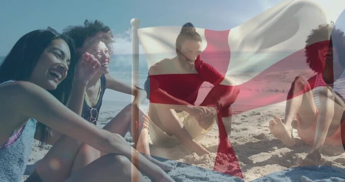 Four friends sitting on sand, red cross flag waving, obscuring and revealing faces for health