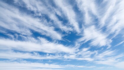 Fototapeta premium A bright blue sky filled with wispy white clouds above