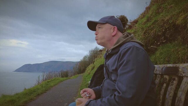 A hiker rambler tourist enjoys the delights of the North Coast of Devon in England via the South West Coastal Path.