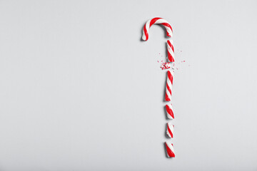 Crushed candy cane on grey background, flat lay with space for text. Christmas treat