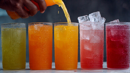 Refreshing colorful drinks being poured for summer celebration