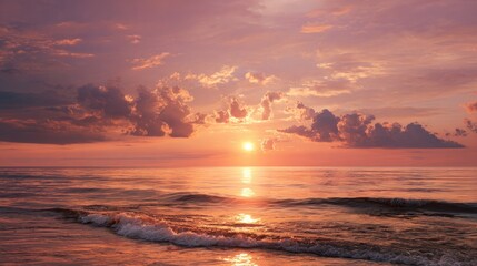 Fototapeta premium Seascape at sunset with calm waves and pink-hued, cloudy sky